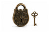 An antique bronze puzzle padlock with an ornate embossed floral pattern and a matching decorative key, displayed on a clean white background.